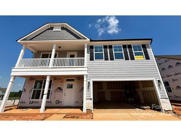Charming two-story home featuring a welcoming front porch, two-car garage, and classic architectural details at 1440 Ardmore Dr # 343, Sherrills Ford, NC 28673