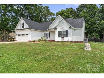 Charming one-story home with manicured lawn, white siding, and black shutters for a classic curb appeal at 145 Mcbride Dr, Rockwell, NC 28138