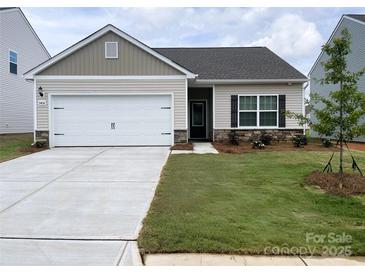 Charming one-story home with a well-manicured lawn, attached two-car garage, and traditional design elements at 3406 Saddlebred Dr, Gastonia, NC 28052