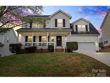 Charming two-story home with a welcoming front porch and well-maintained landscaping at 6019 Timbertop Ln, Charlotte, NC 28215