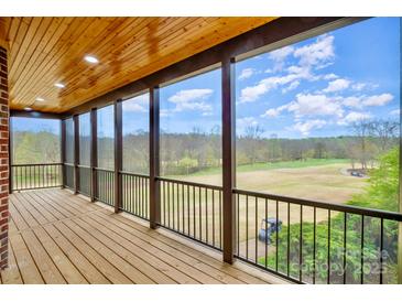 Enjoy outdoor views from this screened porch, complete with wood floors and railing at 1316 Valhalla Dr, Denver, NC 28037