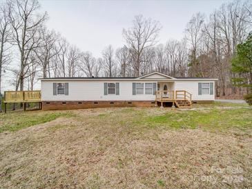 Charming single-story home featuring a cozy front porch and a side deck for outdoor enjoyment at 40701 Nc 740 Hwy, New London, NC 28127