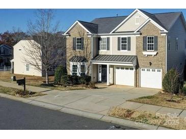 Charming two-story home with brick and siding, attached two-car garage, and well-maintained landscaping at 8304 Prescott Glen Pkwy, Waxhaw, NC 28173