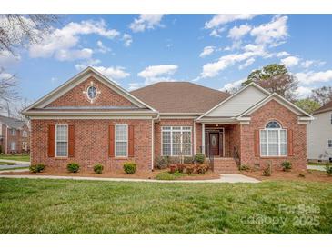 Charming brick home featuring a well-manicured lawn and inviting front entrance at 1730 Sanridge Wind Ln, Charlotte, NC 28262