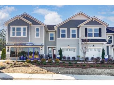 Inviting two-story townhome with a well-manicured lawn and attached garages, presenting a desirable curb appeal at 212 Laura Elizabeth Ln, Clover, SC 29710