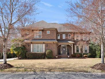 Charming two-story brick home with mature landscaping and inviting front porch at 604 Wisteria Walk Way, Fort Mill, SC 29715