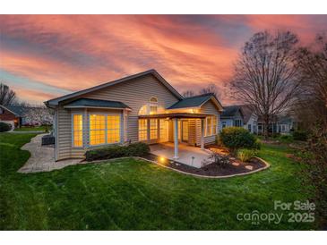 Beautiful backyard with a covered patio and lush green lawn perfect for outdoor relaxation and entertaining at 974 Platinum Dr, Fort Mill, SC 29708