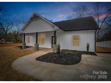 Charming exterior of a home showcasing stone columns and a well-manicured lawn at 1313 Gidney St, Shelby, NC 28150