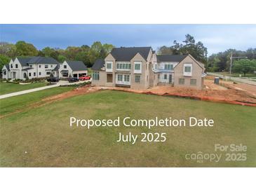 Under-construction exterior shows a light-brick two-story home on a spacious lot, part of a luxury community at 20310 Havenview Dr, Cornelius, NC 28031