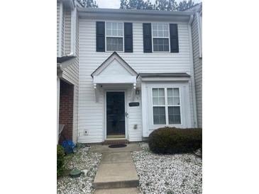 Charming townhome featuring classic black shutters and a well-maintained landscaped yard at 5650 Kimmerly Woods Dr, Charlotte, NC 28215
