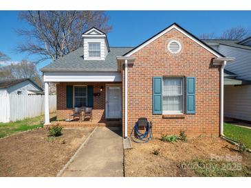 Charming brick home with a dormer window, blue shutters and covered front porch at 311 S Cedar St # C, Lincolnton, NC 28092