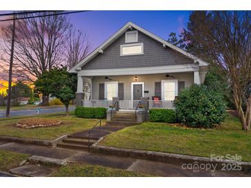 Charming renovated home with inviting front porch, manicured lawn, and classic architectural details at 329 N Ellis St, Salisbury, NC 28144
