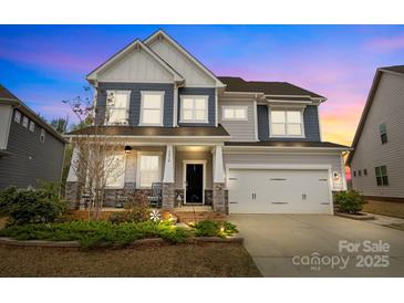 Charming two-story home featuring a welcoming front porch and attached two-car garage at 5030 Lily Pond Cir, Waxhaw, NC 28173