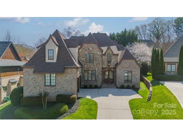 Beautiful brick home featuring stone accents, well-manicured lawn, and inviting curb appeal at 913 Dacavin Dr, Charlotte, NC 28226