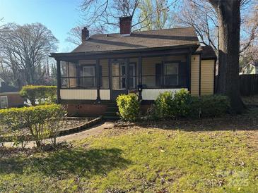 Charming home with a screened-in porch and a well-maintained front yard at 1109 West Blvd, Charlotte, NC 28208