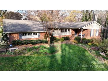 Charming brick home featuring manicured lawn and beautifully landscaped front yard at 116 Jonas Dr, Lincolnton, NC 28092