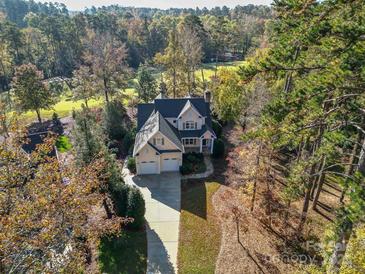 Stunning aerial view of a two-story home with a well-manicured yard surrounded by lush trees at 124 Gatlin Knl # 11, New London, NC 28127