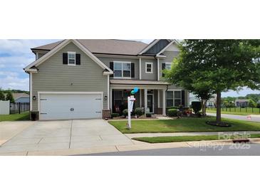 Charming two-story home with a well-manicured lawn and inviting curb appeal with attached garage at 1501 Allegheny Way, Waxhaw, NC 28173