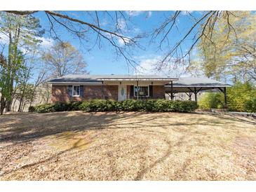 Charming single-story brick home featuring a covered porch and a convenient attached carport at 1923 Tracy Ct, Fort Mill, SC 29708