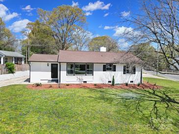 Charming one-story home with manicured lawn, mulch beds, and a newly installed brown roof at 2301 Shamrock Dr, Charlotte, NC 28205
