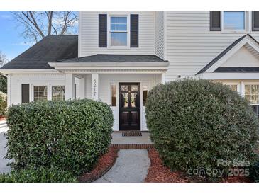 Inviting home entrance with a dark front door framed by manicured bushes and a charming walkway at 3217 Deep Meadow Ln, Charlotte, NC 28210
