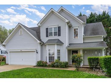 Charming two-story home with vinyl siding, attached garage, and well-manicured lawn, perfect for suburban living at 3905 Farlow Rd, Charlotte, NC 28269