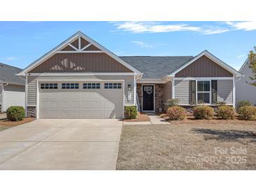 Charming one-story home with a well-manicured lawn and attached two-car garage at 4318 Greenleaf Nw St, Concord, NC 28027