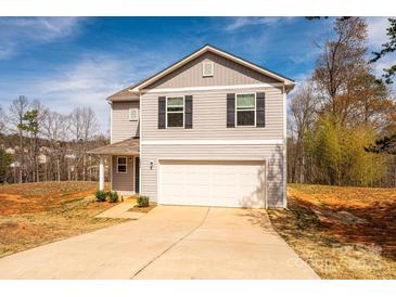 Inviting two-story home boasts a well-maintained lawn and an attached two-car garage at 4852 Stone Dr, Conover, NC 28613