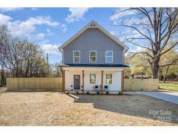 Charming two-story home with a welcoming front porch and a well-maintained, fenced yard at 5108 Potter Rd, Matthews, NC 28104