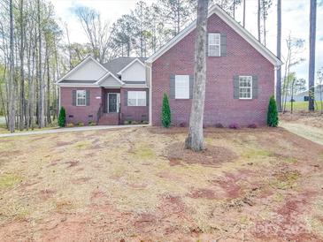 Charming brick home featuring manicured landscaping, symmetrical design, and welcoming front entry at 725 Granna Ln, Lancaster, SC 29720