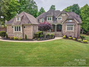 Stunning brick home with manicured lawn, elegant landscaping, and a welcoming entrance at 820 Cooks Cove Rdg, Lake Wylie, SC 29710