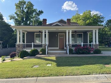 Charming single Gathering home with a welcoming front porch, white pillars, stone accents, and well-manicured lawn at 232 Cromer St, Charlotte, NC 28208