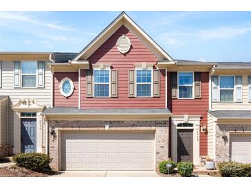 Charming townhome featuring a red facade, brick accents, and a two-car garage at 2446 Alyssa Ln, Charlotte, NC 28208