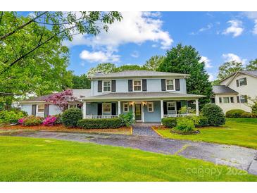Charming two-story home featuring a welcoming front porch and beautifully landscaped front yard at 3726 Providence Rd, Charlotte, NC 28211