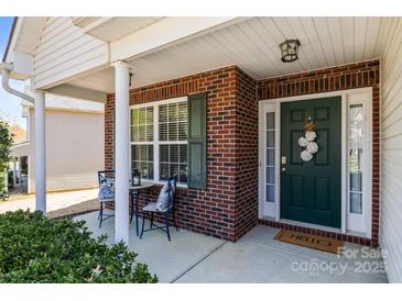 Charming front porch with brick accents, a cozy seating area, and a welcoming entrance to the home at 3908 Parkers Ferry Rd, Fort Mill, SC 29715