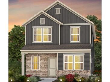 Charming two-story home with a mix of brick and vertical siding, complemented by energy-efficient windows at 15946 Parkside Crossing Dr # 327, Charlotte, NC 28273