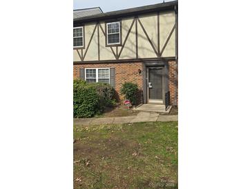 Charming townhouse featuring a classic brick facade and decorative trim at 11011 Park Rd, Charlotte, NC 28226