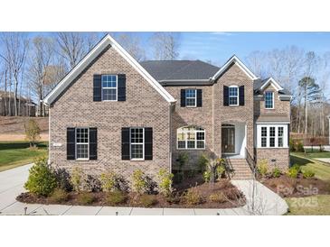 Charming brick home with black shutters, manicured landscaping, and a welcoming entrance at 2017 Belle Grove Dr, Waxhaw, NC 28173