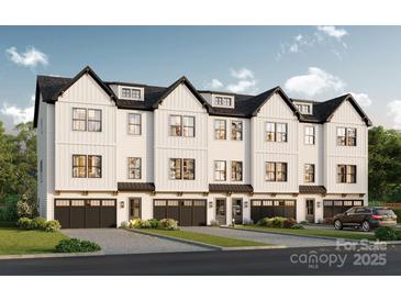 Modern townhome exterior with a black roof, white siding, black trim, and a two-car garage at 313 Yaupon Ct, Fort Mill, SC 29708