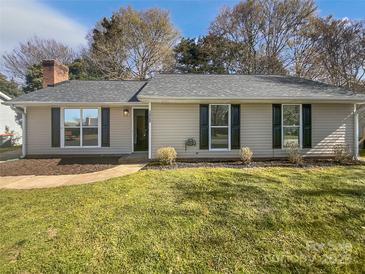 Charming single-story home featuring a well-maintained lawn and classic architectural details at 10707 Copper Field Dr, Pineville, NC 28134