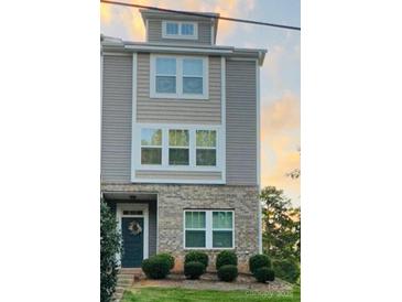 Charming townhouse featuring a brick facade, neutral siding, and neatly trimmed shrubbery at 8232 Waxhaw Hwy, Waxhaw, NC 29173