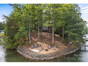 Beautiful wooded home featuring an outdoor patio area with lake access and waterfront views at 121 Rhinehill Dr, Mooresville, NC 28117