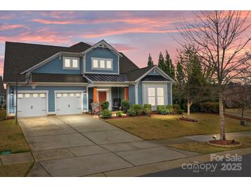 Charming two-story home with a two-car garage, landscaped yard, and inviting curb appeal at sunset at 12619 Old Westbury Dr, Cornelius, NC 28031
