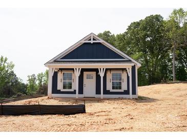 Charming blue home with white trim, a covered porch, and classic design elements at 1432 Blackbird Dr, Clover, SC 29710
