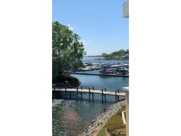 Scenic marina view featuring boats, pier, and calm waters on a clear day at 18009 Kings Point Dr # C, Cornelius, NC 28031