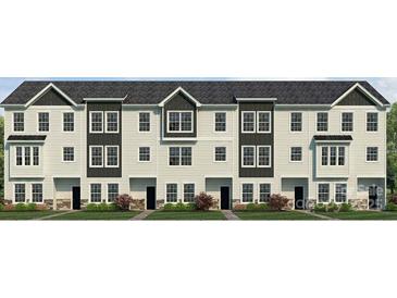 Three-story townhouse exterior with white and dark gray siding, complemented by black window frames and well-maintained landscaping at 234 E Morehouse Ave # Twnh E, Mooresville, NC 28117