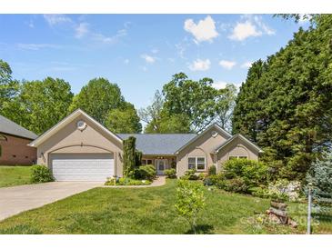 Charming single-story home featuring an attached two-car garage and inviting curb appeal with lush landscaping at 2341 Shannon Dr, Belmont, NC 28012