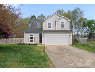 Charming two-story home featuring a well-manicured lawn and attached two-car garage at 3904 Crimson Wing Dr, Indian Trail, NC 28079