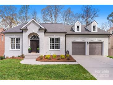 Charming brick home featuring a two-car garage and a well-manicured front yard at 4012 Cambridge Hill Ln, Charlotte, NC 28270