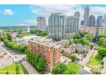 Condo building with city skyline views and mature landscaping at 715 N Church St # 301, Charlotte, NC 28202